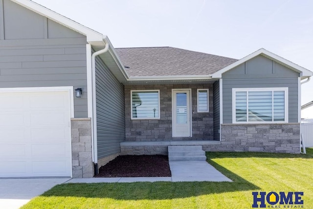 doorway to property with a yard and a garage