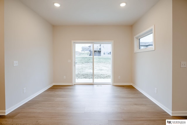 spare room with light hardwood / wood-style floors