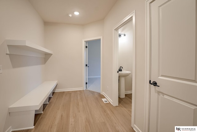 mudroom with light hardwood / wood-style flooring