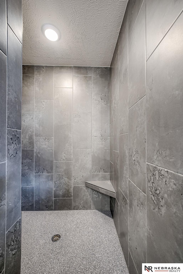 bathroom featuring a shower and a textured ceiling