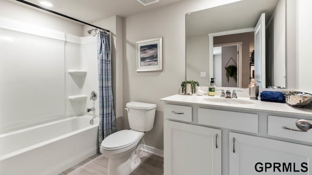 full bathroom with hardwood / wood-style flooring, toilet, vanity, and shower / bath combination with curtain