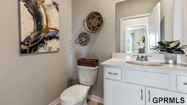 bathroom featuring toilet and vanity