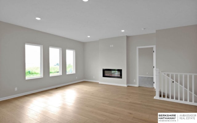 unfurnished living room featuring light hardwood / wood-style floors