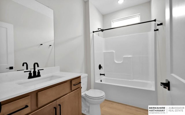 full bathroom with toilet, tub / shower combination, wood-type flooring, and vanity