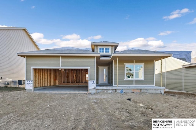 view of front of property featuring covered porch and a garage