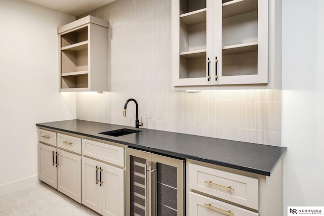 kitchen with wine cooler, backsplash, and sink