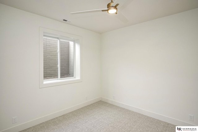 carpeted spare room with ceiling fan and a wealth of natural light