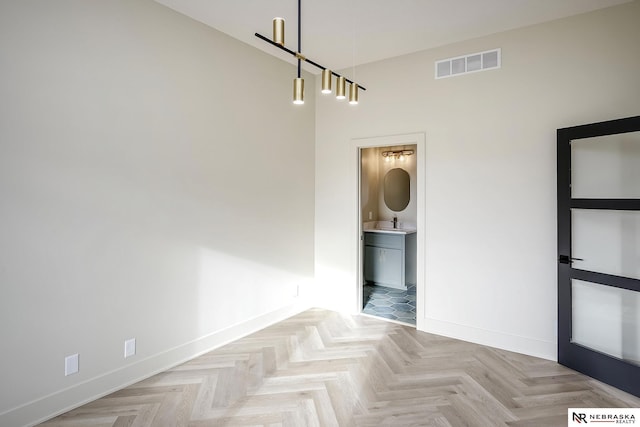 empty room featuring light parquet floors and sink