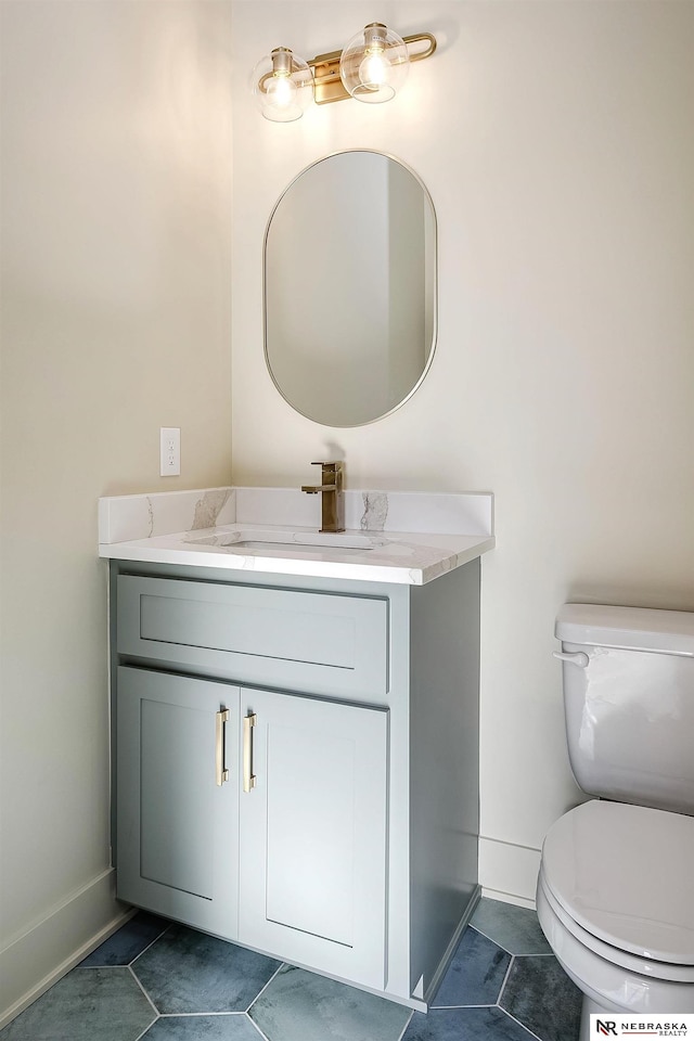 bathroom with tile patterned floors, toilet, and vanity