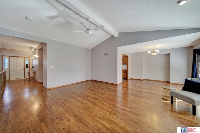 unfurnished living room featuring ceiling fan with notable chandelier, vaulted ceiling with beams, light hardwood / wood-style floors, and a textured ceiling