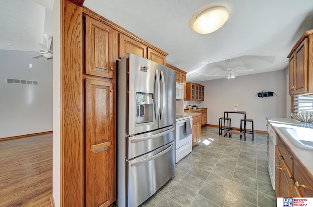 kitchen with ceiling fan and white appliances