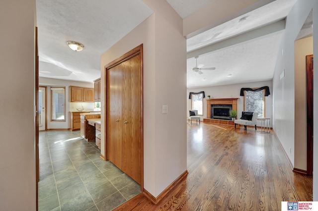 corridor featuring a textured ceiling and wood-type flooring