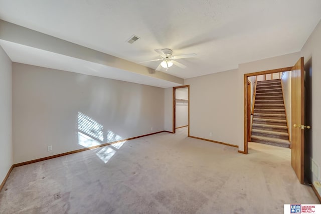 empty room featuring light carpet and ceiling fan