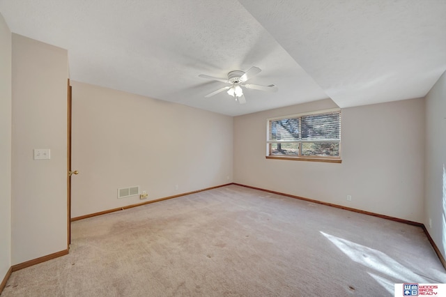 spare room with light carpet and ceiling fan