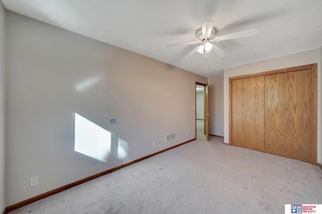 unfurnished bedroom with ceiling fan, carpet, and a closet