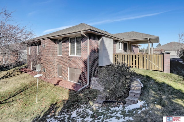 view of side of home with a yard