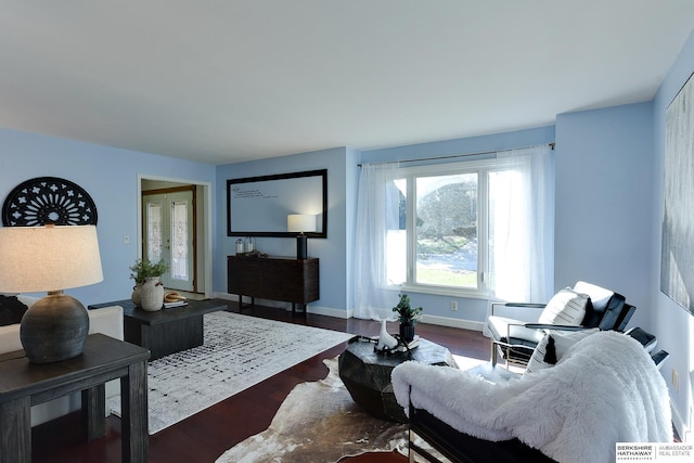 living room with dark hardwood / wood-style flooring