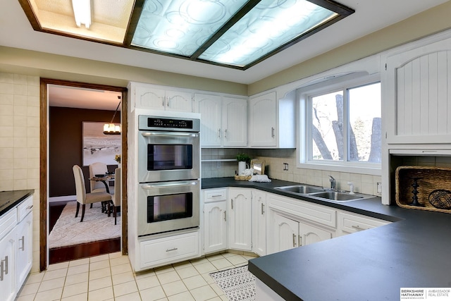 kitchen featuring sink, white cabinetry, and double oven