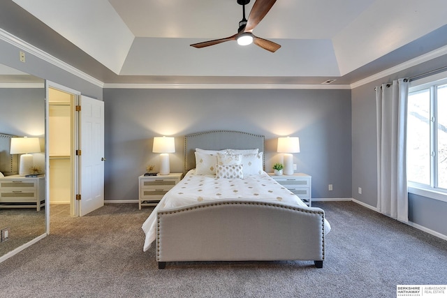 bedroom featuring ceiling fan, carpet flooring, a tray ceiling, and crown molding