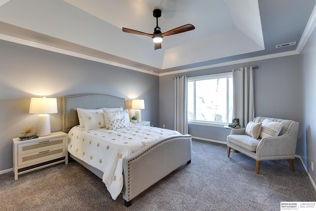 bedroom with ceiling fan, dark carpet, crown molding, and a tray ceiling