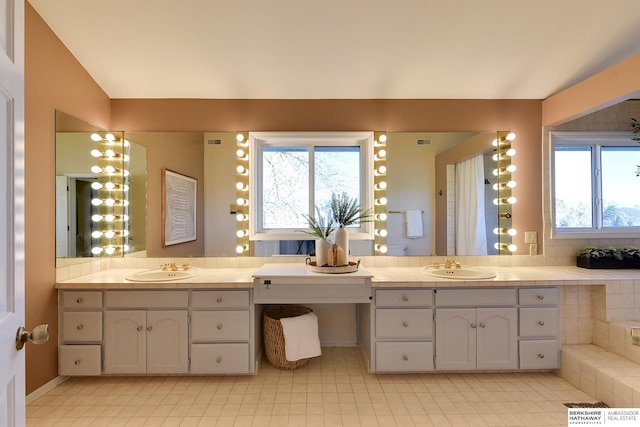 bathroom featuring vanity, a wealth of natural light, and tile patterned flooring