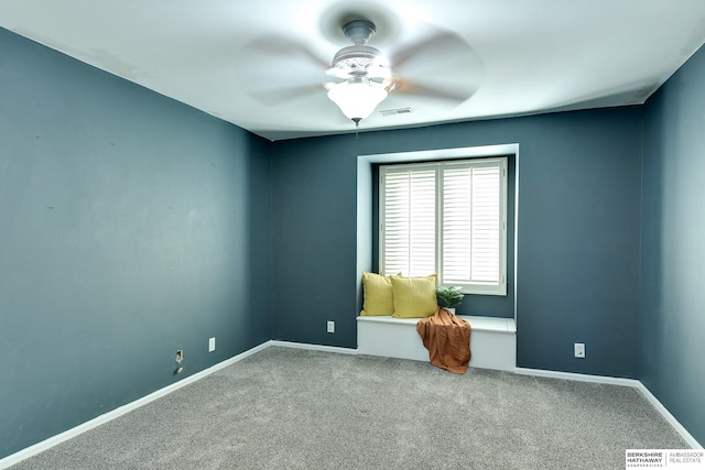 carpeted empty room featuring ceiling fan