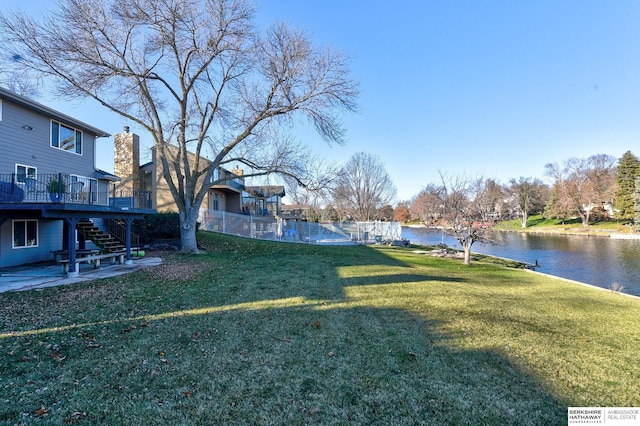 view of yard featuring a deck with water view