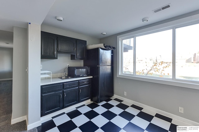 kitchen featuring sink and black appliances