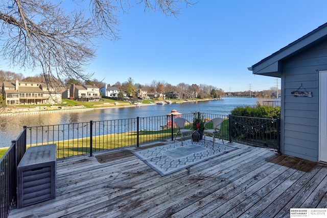 wooden terrace with a playground and a water view