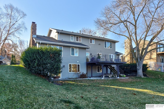 back of house featuring a wooden deck and a yard