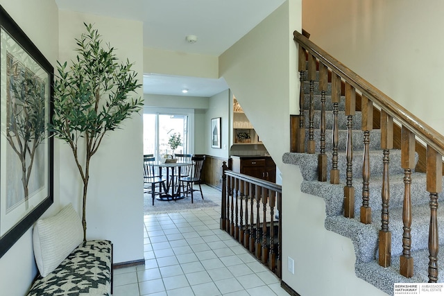 stairway with tile patterned flooring