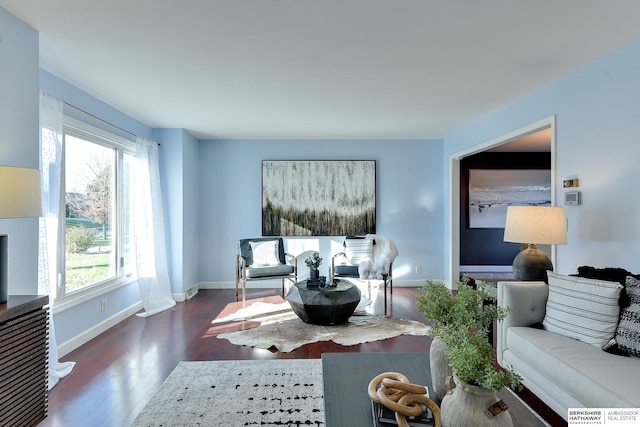 living room featuring a healthy amount of sunlight and dark hardwood / wood-style floors