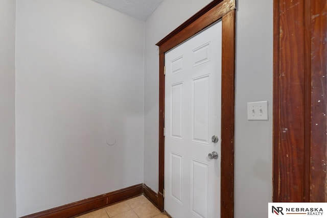 corridor featuring light tile patterned flooring