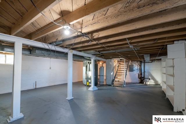 basement with electric panel and heating unit