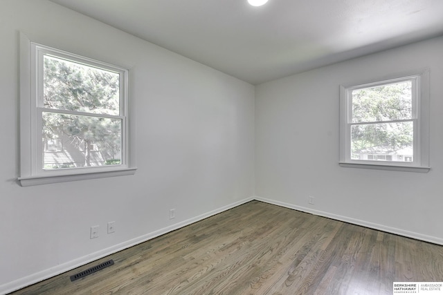 spare room with hardwood / wood-style floors