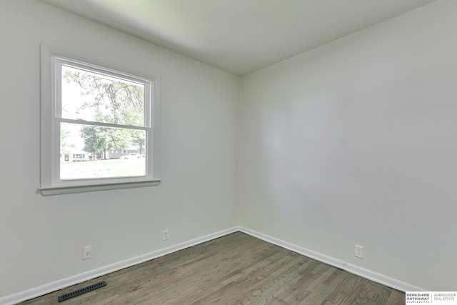 unfurnished room featuring dark hardwood / wood-style flooring