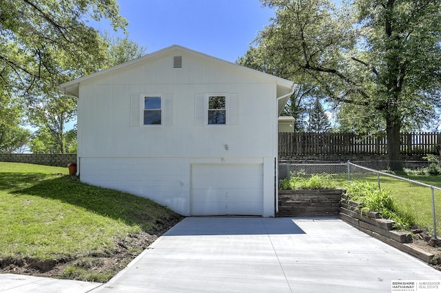 view of property exterior with a garage and a yard