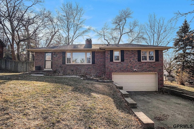 view of front of home with a garage and a front lawn