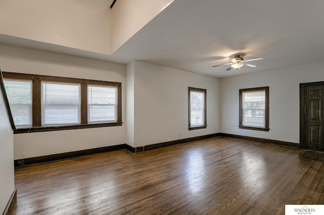 unfurnished living room with ceiling fan and dark hardwood / wood-style floors