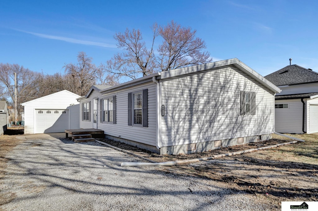 view of side of home featuring an outbuilding and a garage