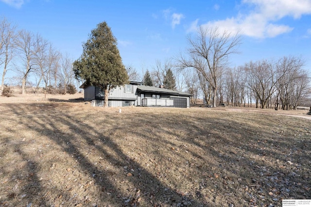 exterior space featuring a garage and a rural view