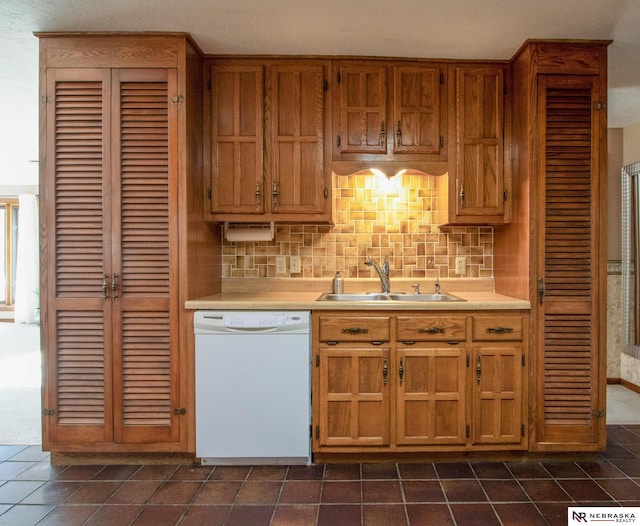 kitchen featuring sink, decorative backsplash, and dishwasher