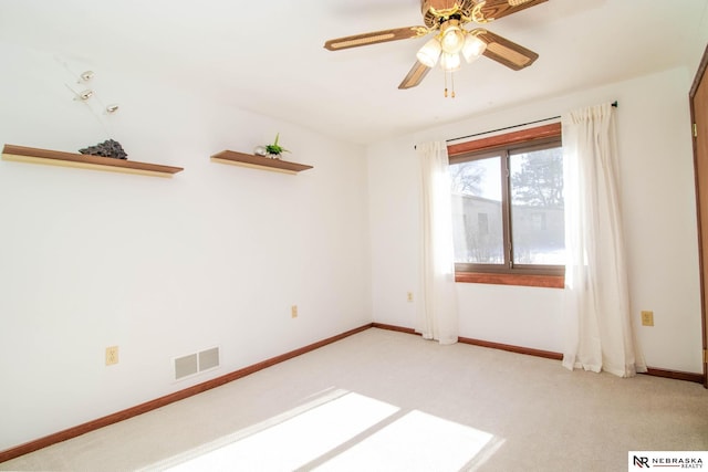 unfurnished room with ceiling fan and light carpet