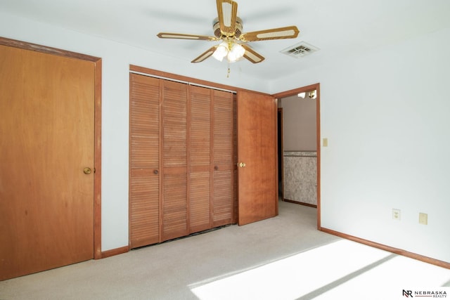 unfurnished bedroom featuring ceiling fan and light colored carpet