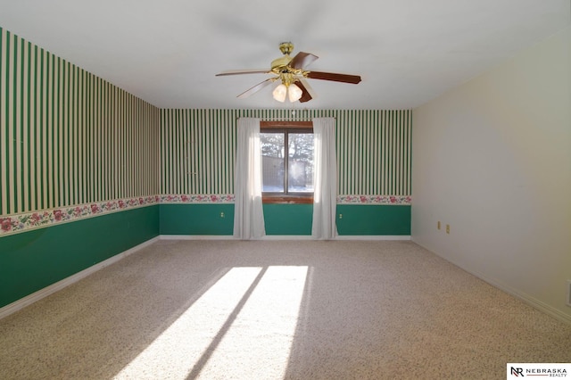 carpeted empty room featuring ceiling fan