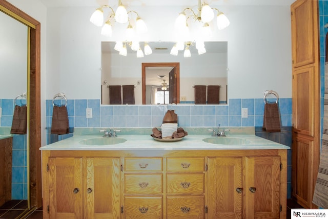 bathroom featuring tasteful backsplash, a notable chandelier, and vanity