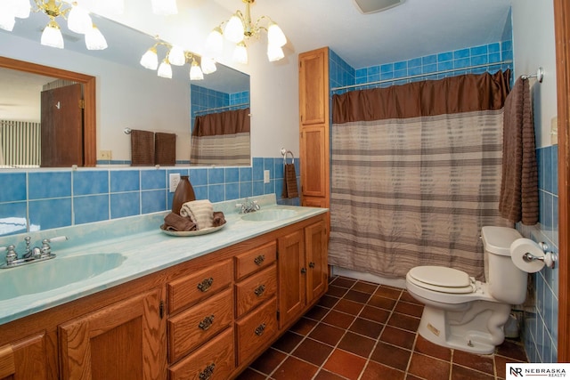 bathroom with curtained shower, decorative backsplash, toilet, vanity, and a chandelier