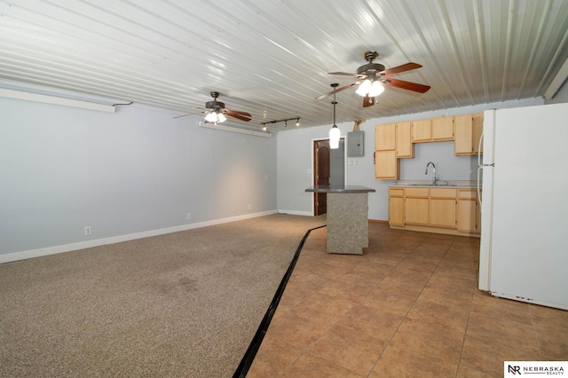 kitchen with light brown cabinetry, rail lighting, white fridge, sink, and ceiling fan