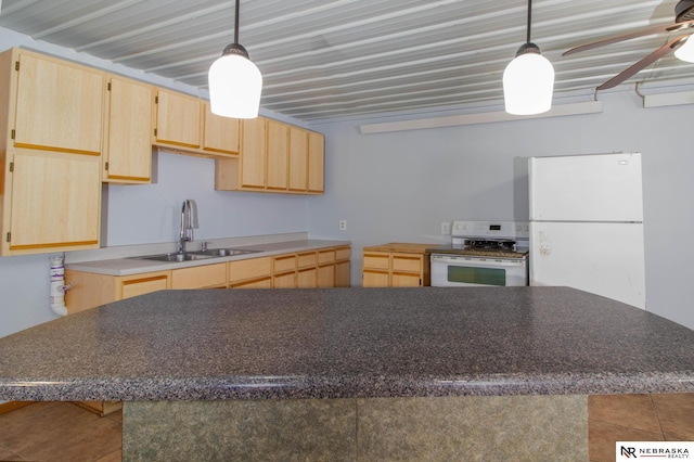 kitchen with sink, white appliances, light brown cabinets, and hanging light fixtures