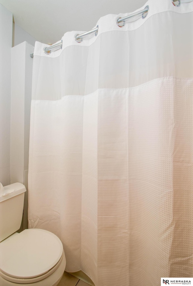 bathroom featuring tile patterned floors and toilet